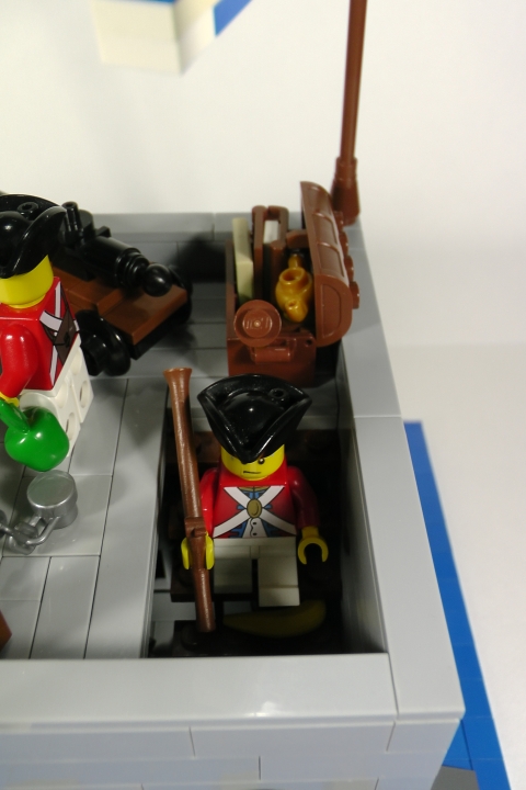 LEGO MOC - LEGO-contest 24x24: 'Pirates' - Бомба для губернатора или Драма на КПП: Рядовой Нортон, изрядно попотев наверху, спускается вниз и упорно не замечает кожуру съеденного Протектором банана, лежащую на ступеньке.